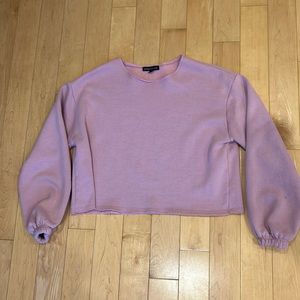 Pink baggy crop top with cuffed sleeves